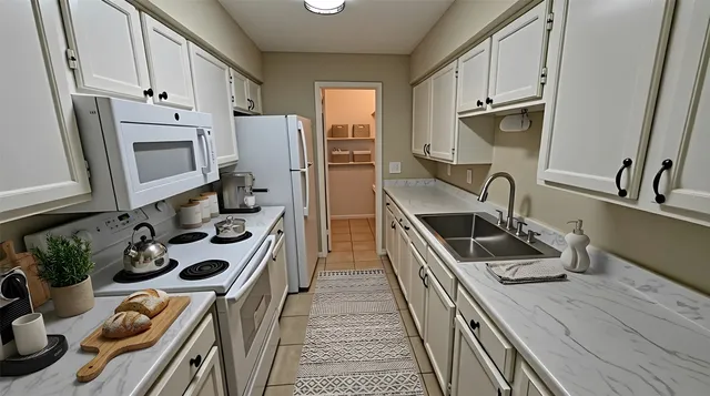 a kitchen with stainless steel appliances a sink stove and refrigerator