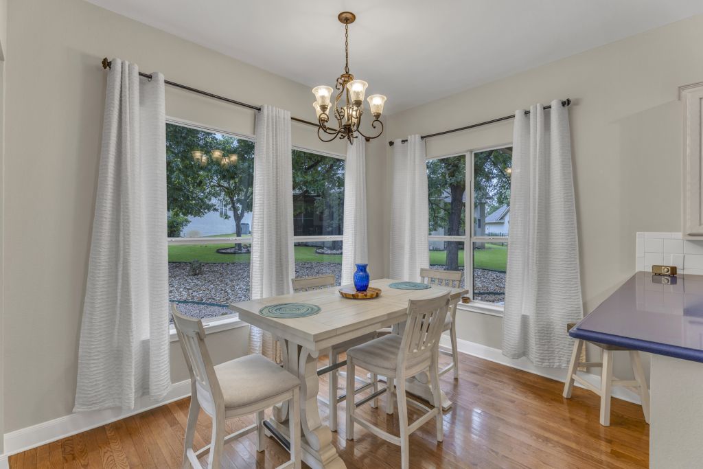 144 Cattle Trail Way Georgetown, TX 78633 - Photo 6 of 37 Hardwood floors and generous natural light create an inviting dining space for entertaining.