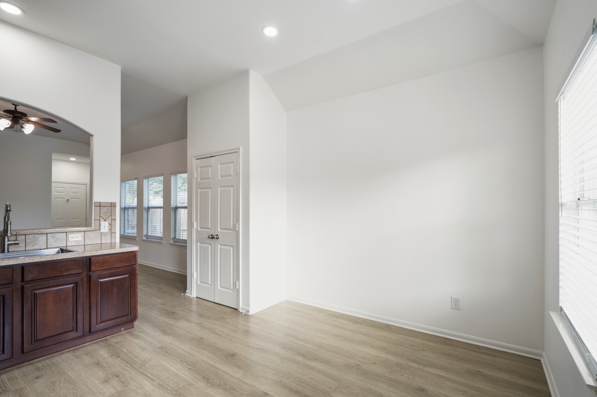 21810 Mansfield Bluff Lane Spring, TX 77379 - Photo 12 of 34 The breakfast area sits just off the kitchen, offering a dedicated spot for everyday meals with natural light coming in from the nearby windows. Double doors open to the pantry, keeping storage easily accessible while maintaining a clean, tucked-away look.