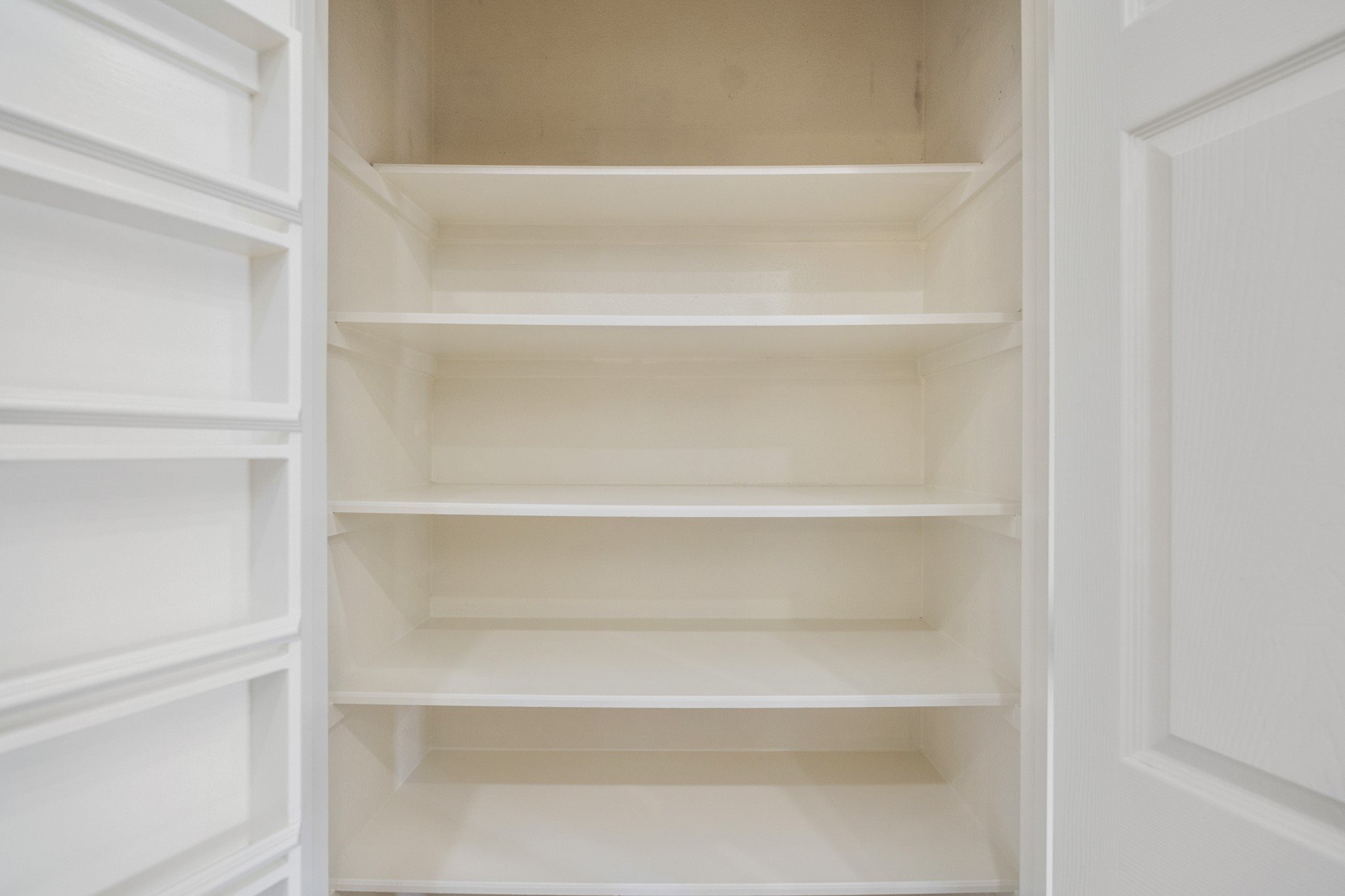21810 Mansfield Bluff Lane Spring, TX 77379 - Photo 13 of 34 Inside the pantry, built-in shelving provides plenty of space to keep everything organized and within reach, with a layout that makes it easy to see and access what you need.