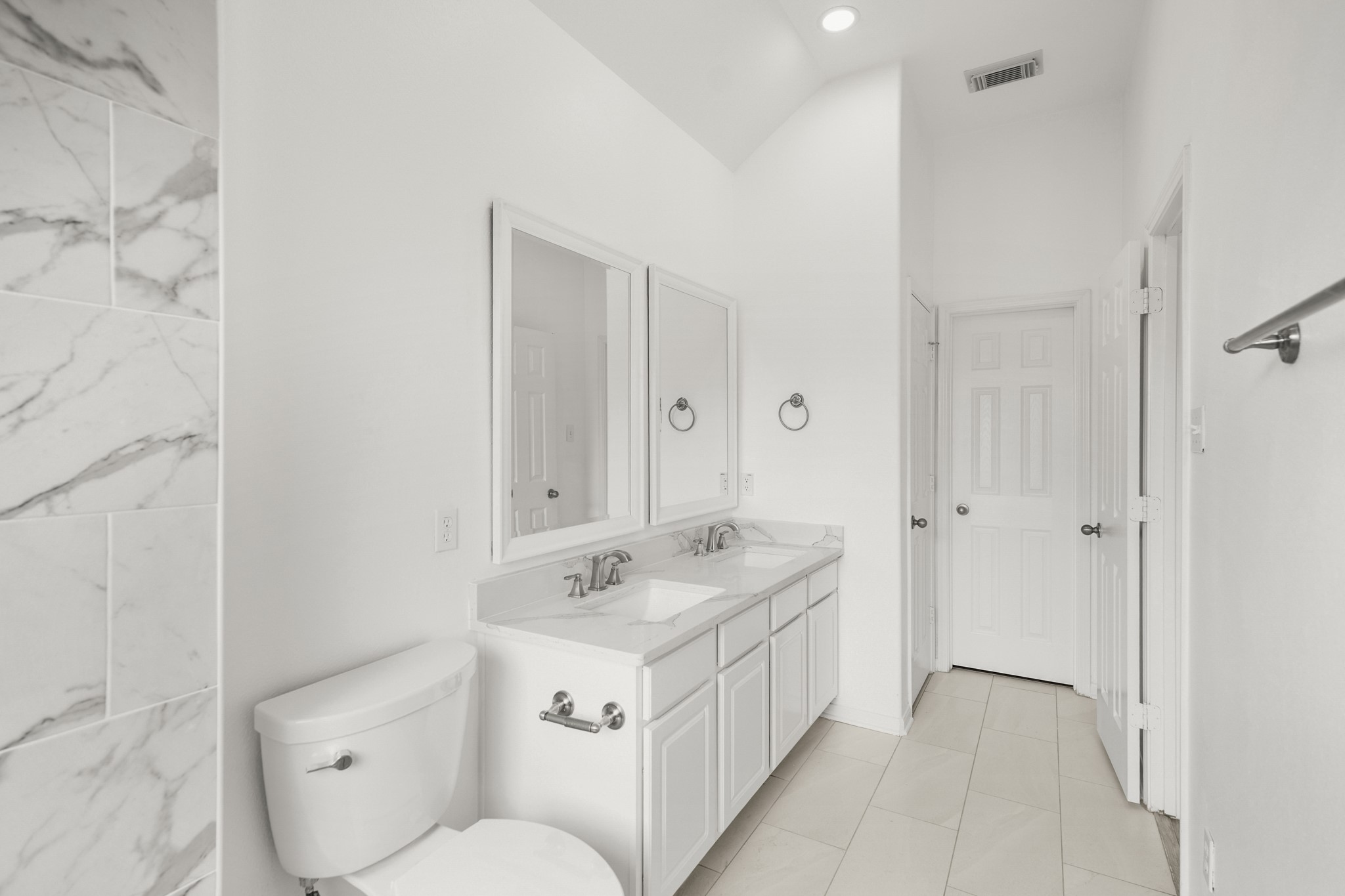 21810 Mansfield Bluff Lane Spring, TX 77379 - Photo 19 of 34 From the shower, this view looks back across the primary bath with the dual-sink vanity to the left. Straight ahead, a door leads into the walk-in closet, keeping everything connected and easy to access.