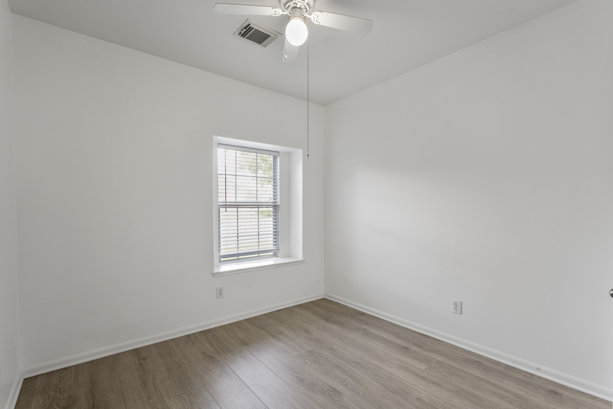21810 Mansfield Bluff Lane Spring, TX 77379 - Photo 23 of 34 This secondary bedroom sits just off the living area, with a window bringing in natural light and a closet tucked along the wall.