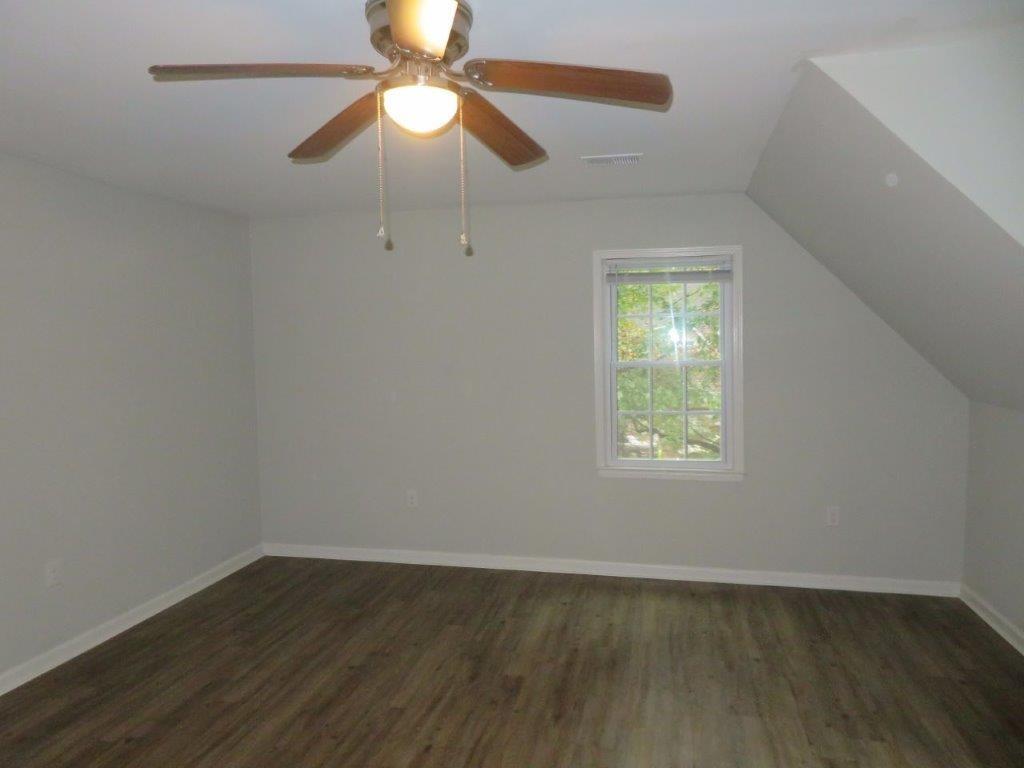 40 Lake Court Stockbridge, GA 30281 - Photo 12 of 24 an empty room with wooden floor fan and windows