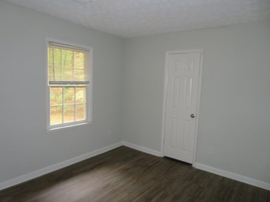 40 Lake Court Stockbridge, GA 30281 - Photo 14 of 24 a view of an empty room with wooden floor and a window