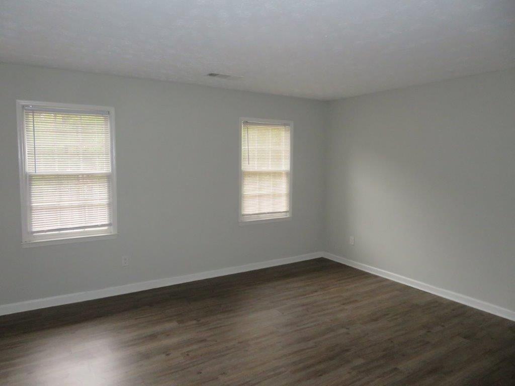 40 Lake Court Stockbridge, GA 30281 - Photo 17 of 24 an empty room with wooden floor and windows