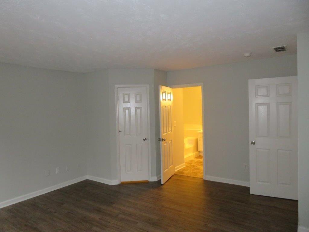 40 Lake Court Stockbridge, GA 30281 - Photo 18 of 24 a view of an empty room with wooden floor and a window