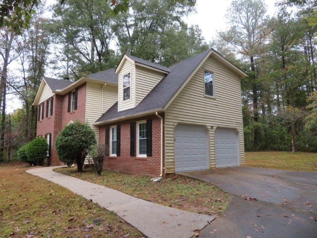 40 Lake Court Stockbridge, GA 30281 - Photo 2 of 24 a front view of a house with a yard and garage