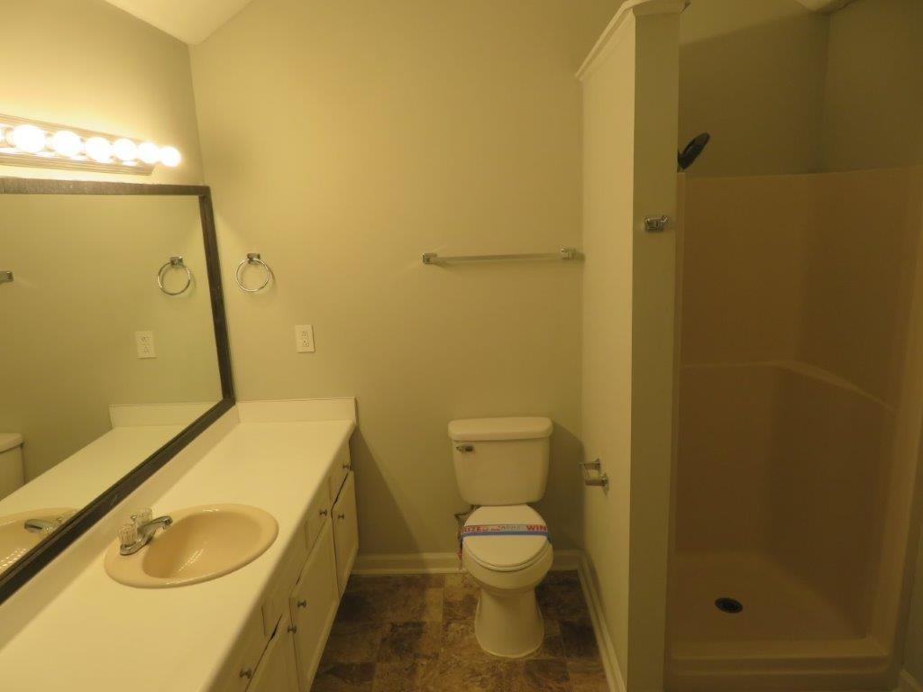 40 Lake Court Stockbridge, GA 30281 - Photo 21 of 24 a bathroom with a sink toilet and shower