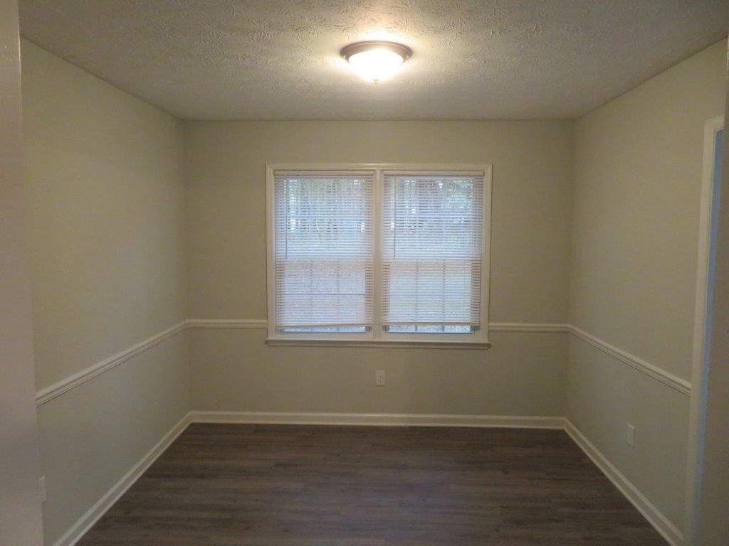40 Lake Court Stockbridge, GA 30281 - Photo 6 of 24 an empty room with wooden floor and windows