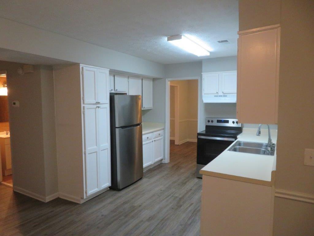40 Lake Court Stockbridge, GA 30281 - Photo 8 of 24 a kitchen with a refrigerator sink and wooden floor