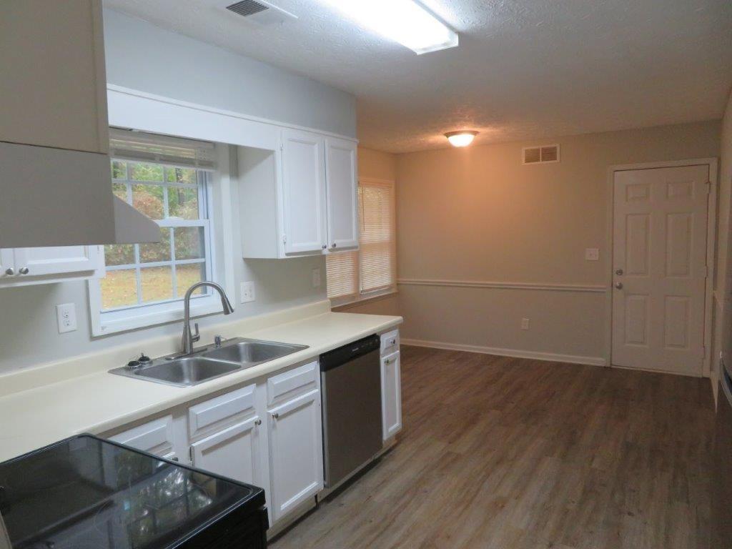 40 Lake Court Stockbridge, GA 30281 - Photo 9 of 24 a kitchen with a sink cabinets and wooden floor
