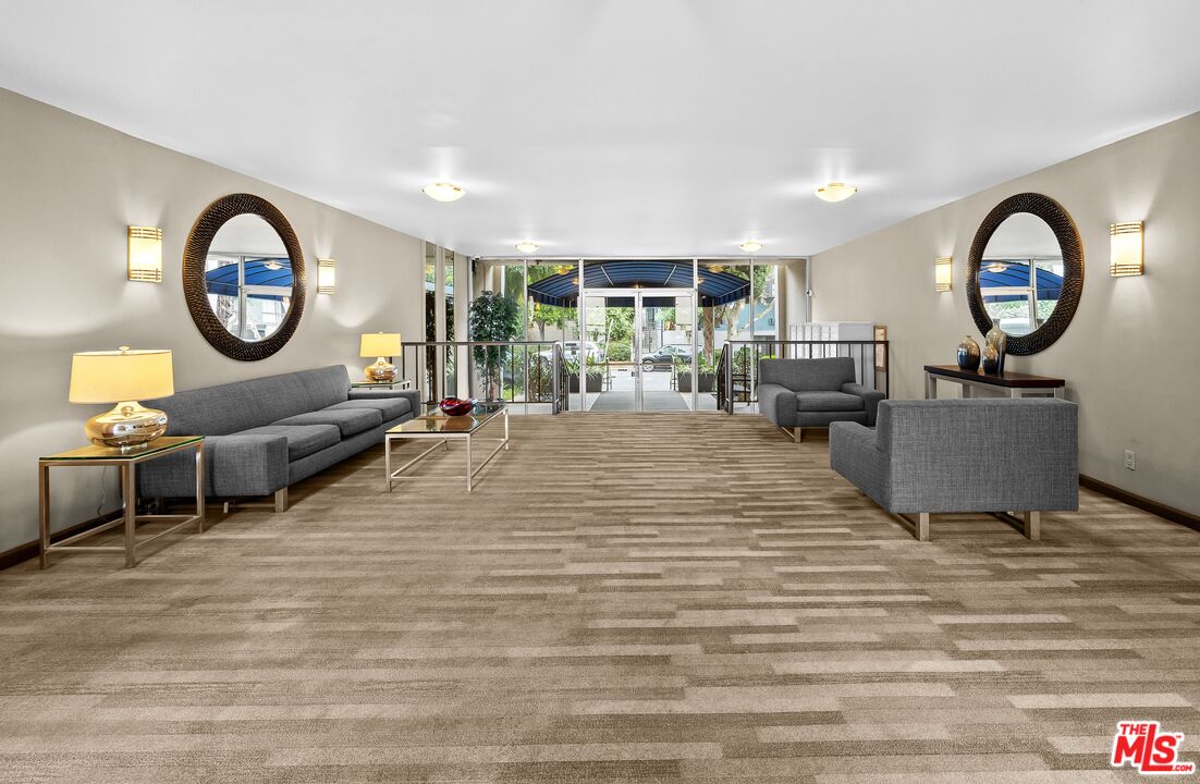 927 North Kings Road, Unit 212 West Hollywood, CA 90069 - Photo 13 of 14 a living room with furniture a large window and a fireplace