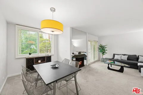 a view of a dining room with furniture and a window