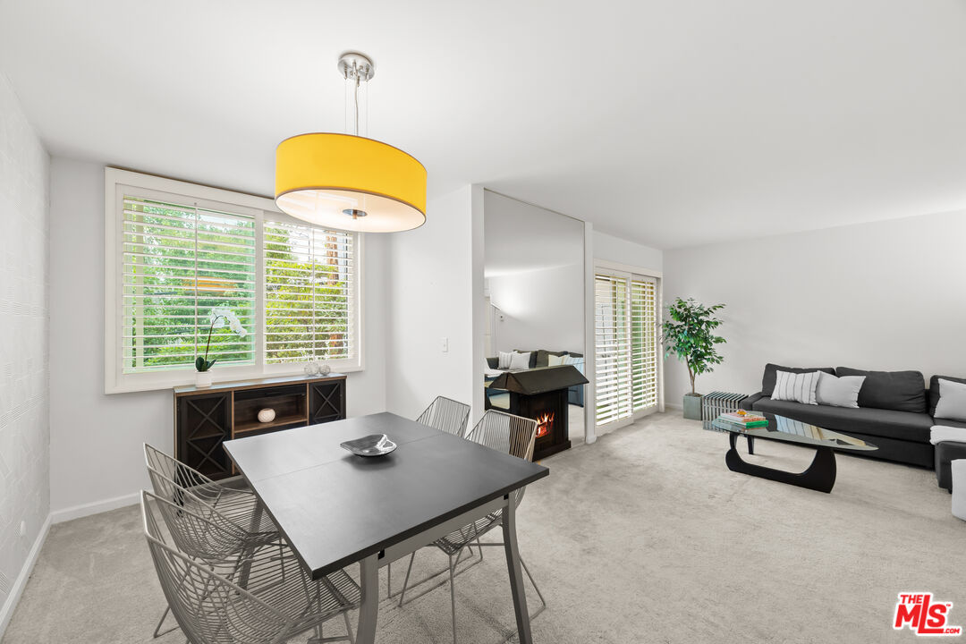 927 North Kings Road, Unit 212 West Hollywood, CA 90069 - Photo 3 of 14 a view of a dining room with furniture and a window
