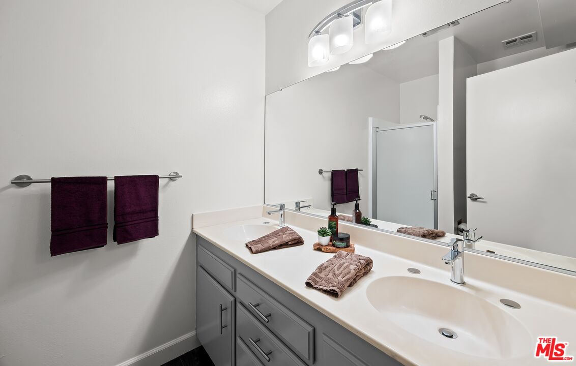 927 North Kings Road, Unit 212 West Hollywood, CA 90069 - Photo 8 of 14 a bathroom with a double vanity sink and mirror