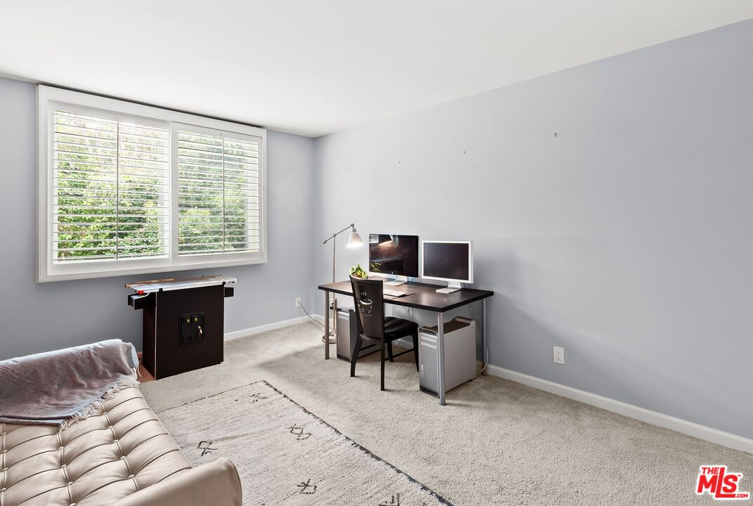 927 North Kings Road, Unit 212 West Hollywood, CA 90069 - Photo 9 of 14 a bedroom with a bed and a window