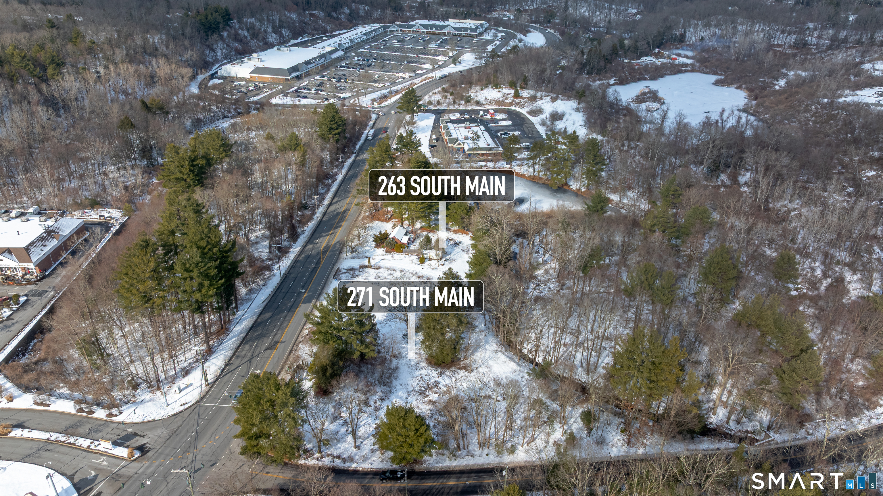 263-271 South Main Street Newtown, CT 06470 - Photo 4 of 24 a sign that is on the side of a road