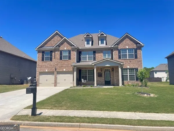 a front view of a house with a yard