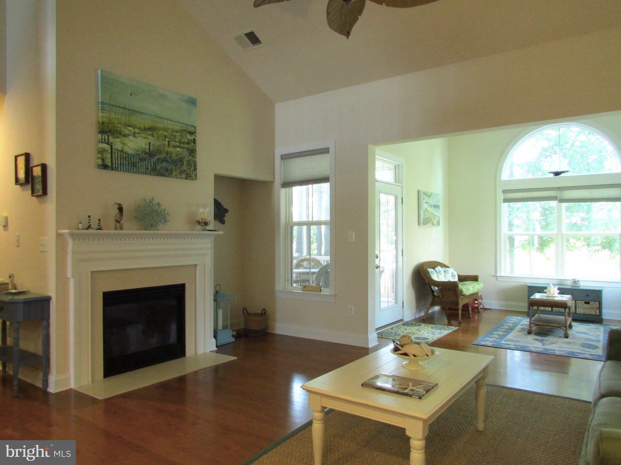 30671 Kingbird Court Ocean View, DE 19970 - Photo 13 of 21 a living room with furniture a fireplace and a large window