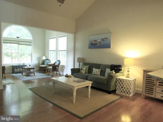a living room with fireplace furniture and a large window