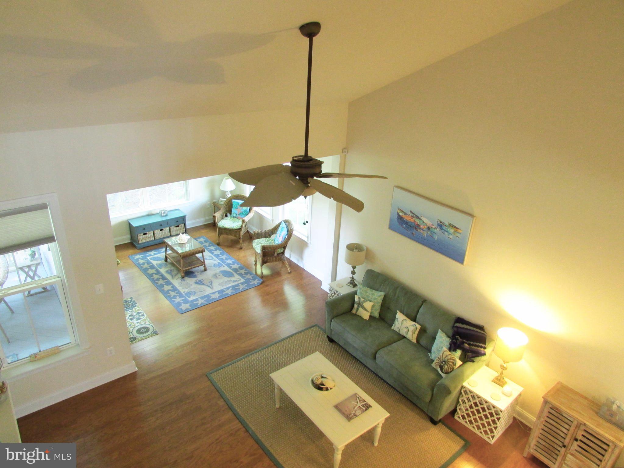 30671 Kingbird Court Ocean View, DE 19970 - Photo 16 of 21 a living room with furniture and a floor to ceiling window