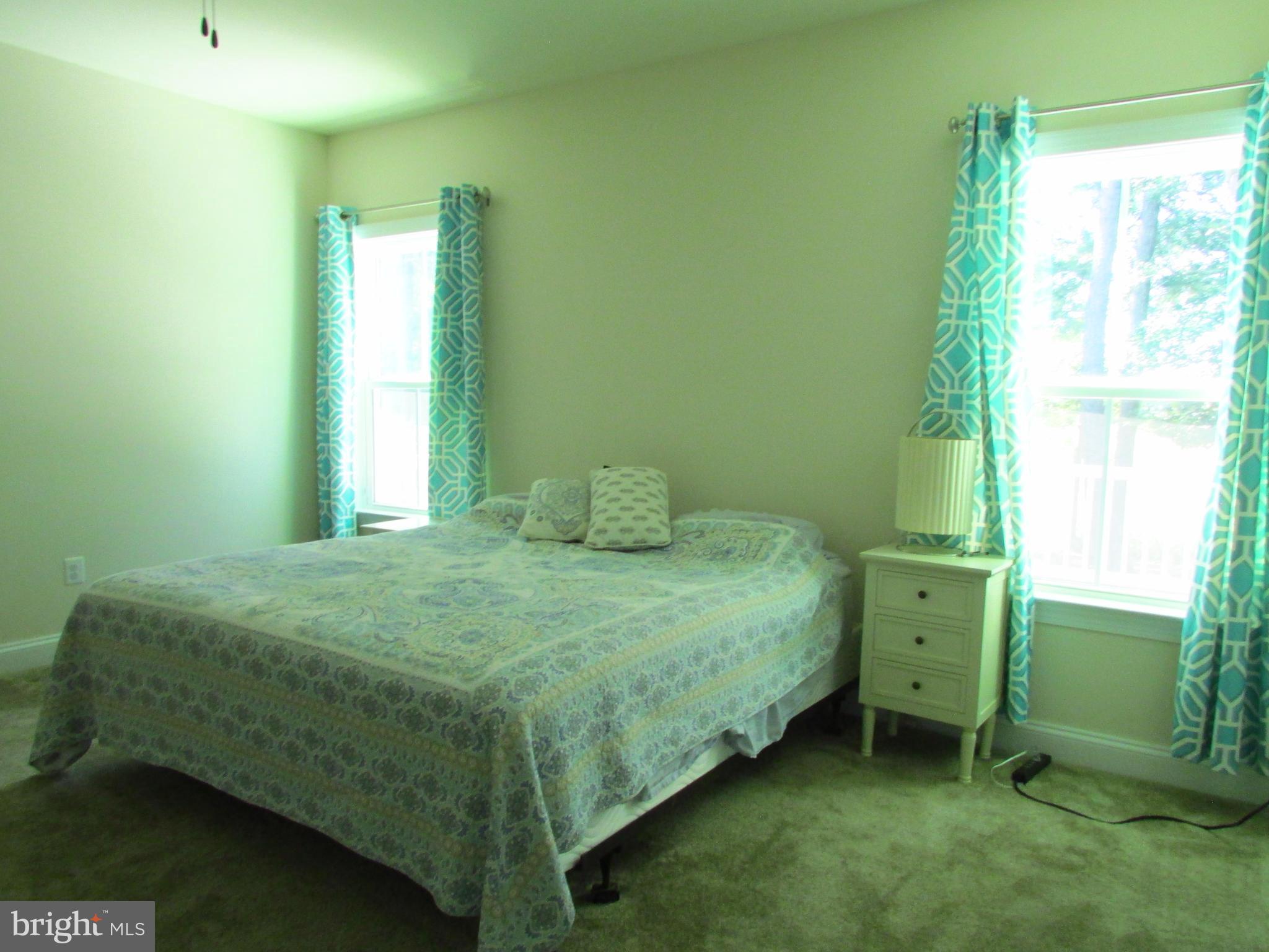 30671 Kingbird Court Ocean View, DE 19970 - Photo 7 of 21 a bedroom with a bed and a window