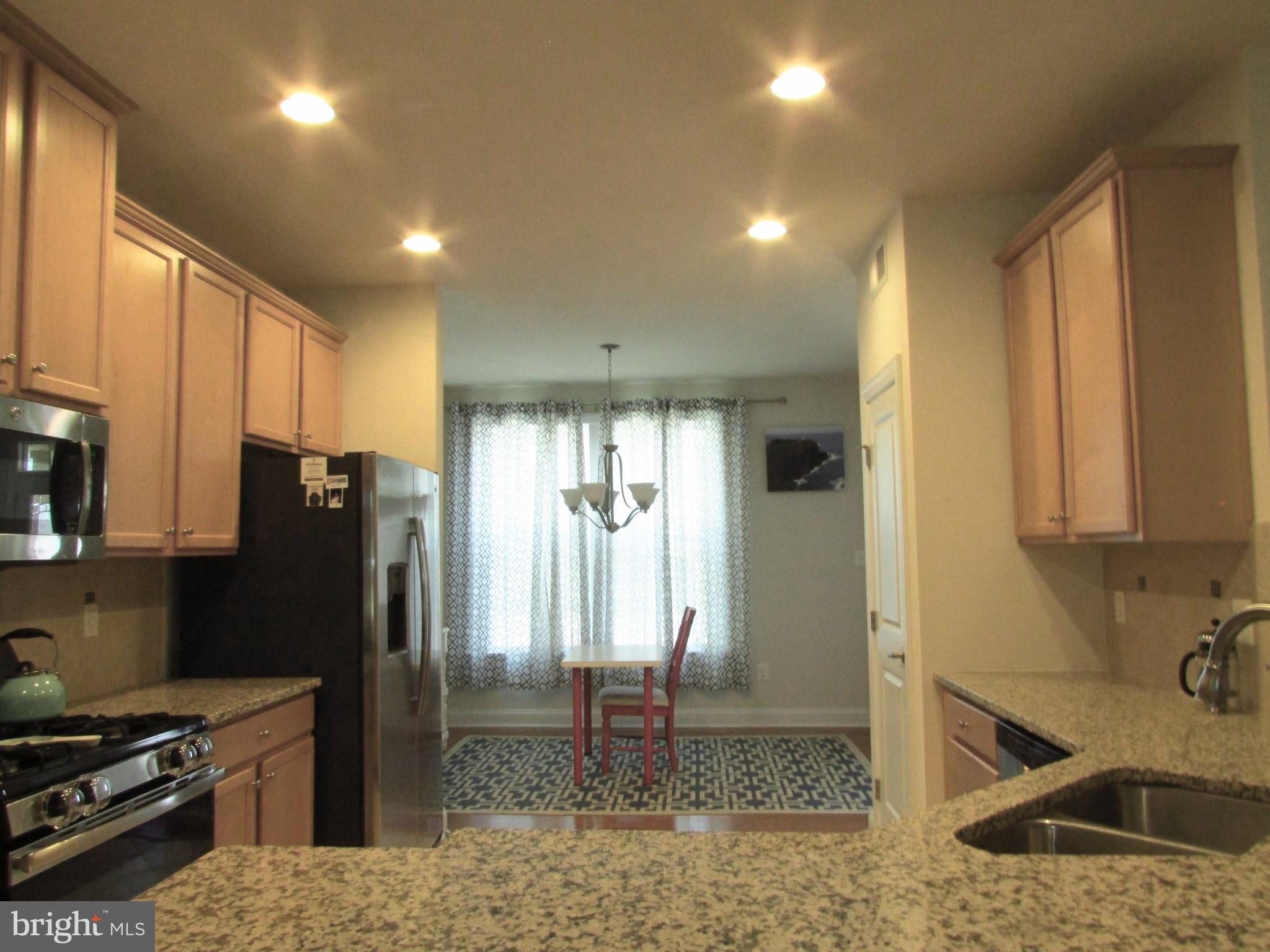 30671 Kingbird Court Ocean View, DE 19970 - Photo 10 of 21 a kitchen with stainless steel appliances granite countertop a refrigerator a stove and a sink