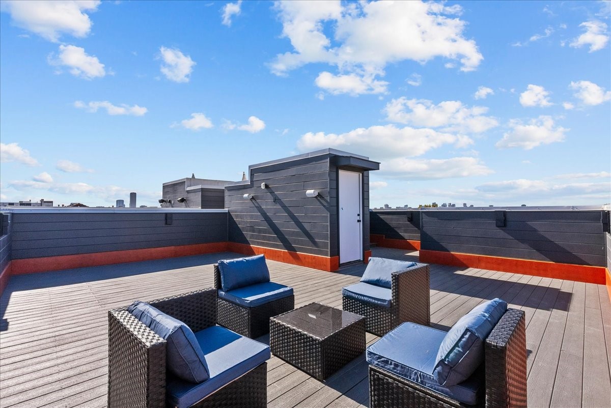 516 Reinerman Street Houston, TX 77007 - Photo 8 of 42 Spacious rooftop terrace with sleek modern design, featuring outdoor seating and expansive city views. Perfect for entertaining or relaxing.