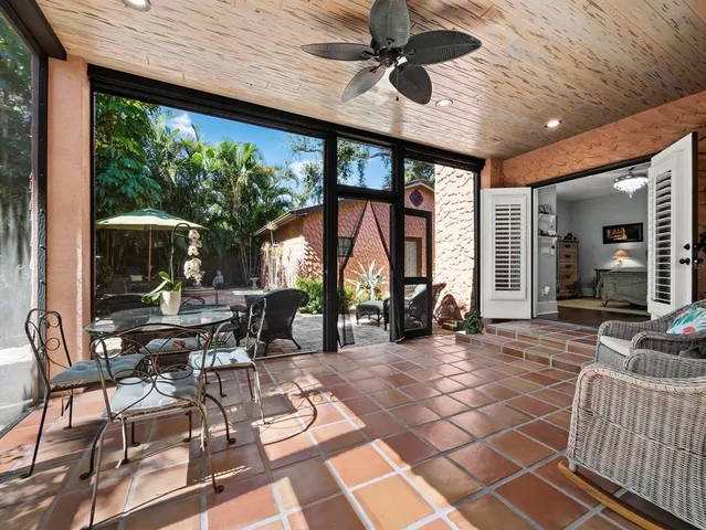 a view of a patio with dining table and chairs