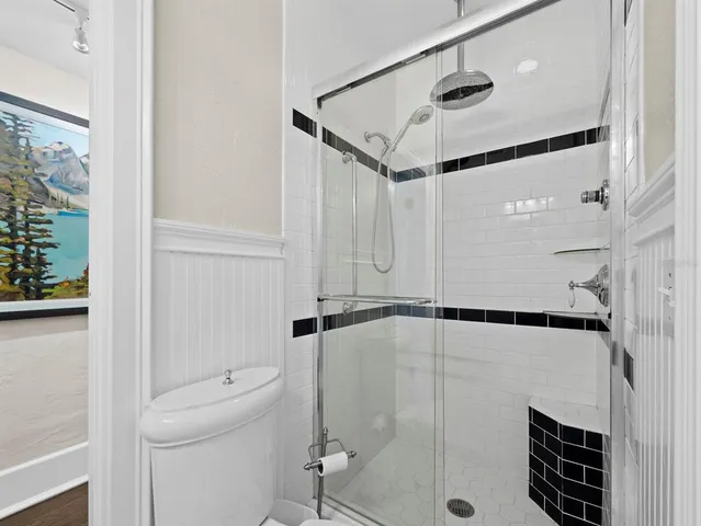 a bathroom with a shower and a toilet