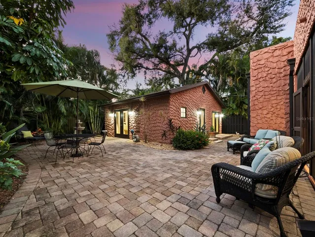 a view of a house with backyard and sitting area