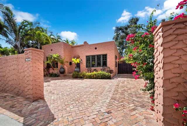 a view of a house with a yard and garden