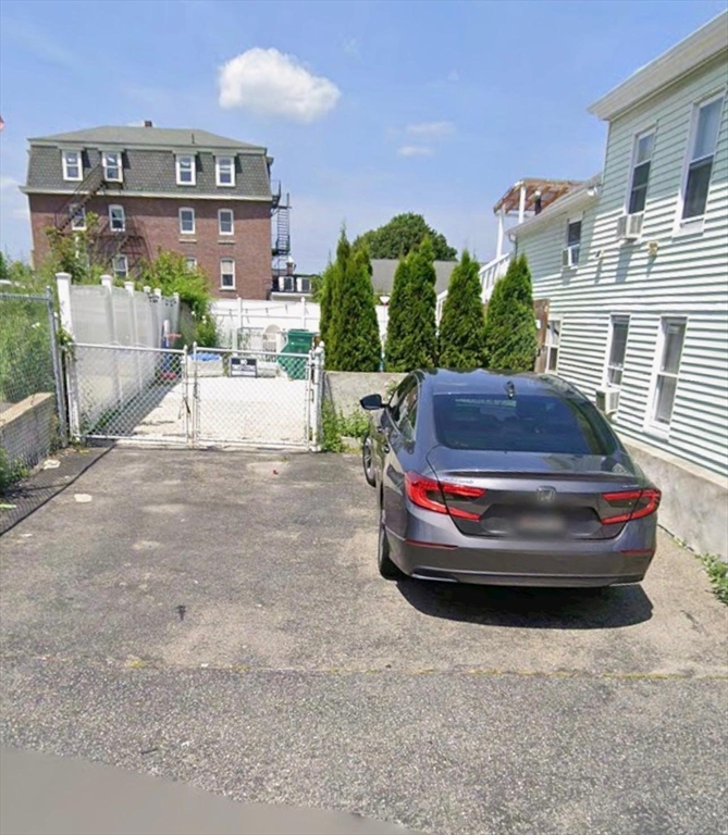 8-10 Cady Street Lowell, MA 01852 - Photo 7 of 11 a view of a house with a back yard