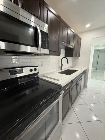 a kitchen with a stove and a microwave