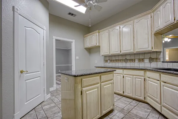 a kitchen with stainless steel appliances granite countertop a sink and cabinets