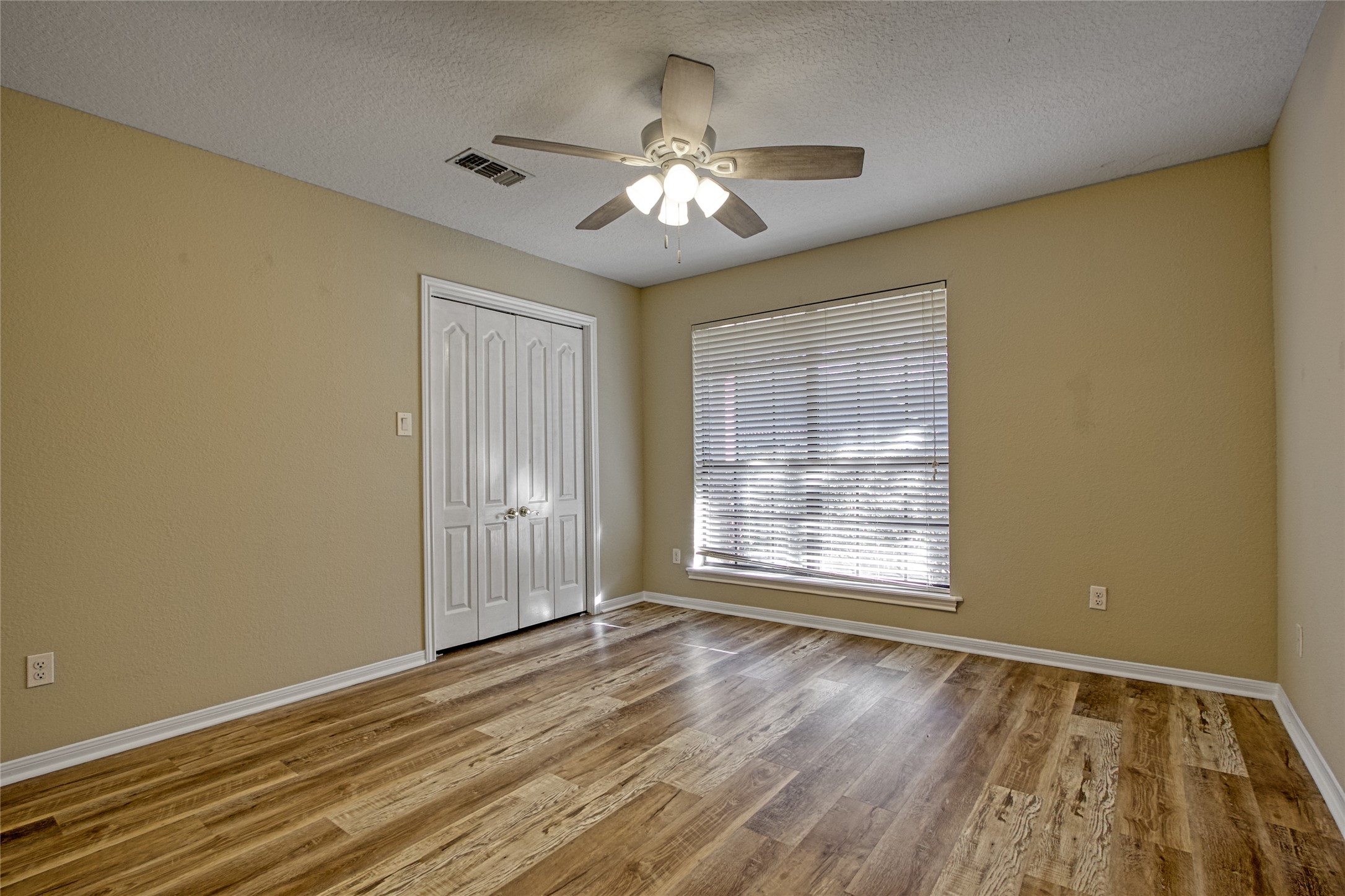 9 North Cay Angleton, TX 77515 - Photo 16 of 30 a view of an empty room with wooden floor and a window