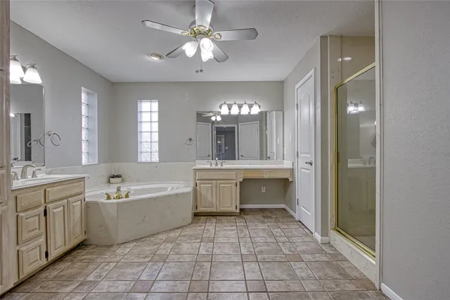a spacious bathroom with a mirror a sink and a shower