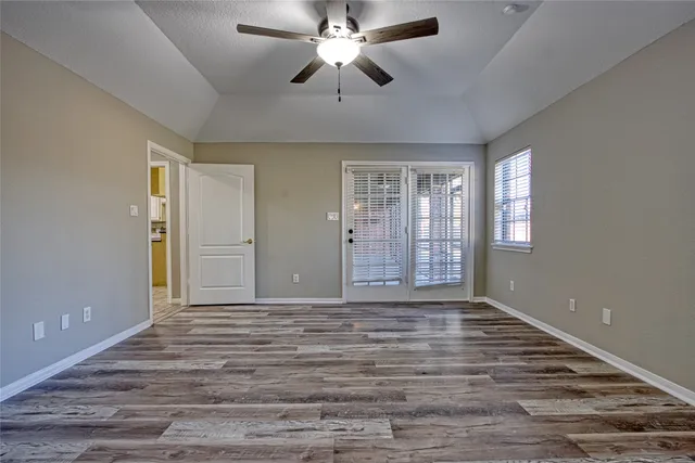 a view of hallway with furniture and floor to ceiling window
