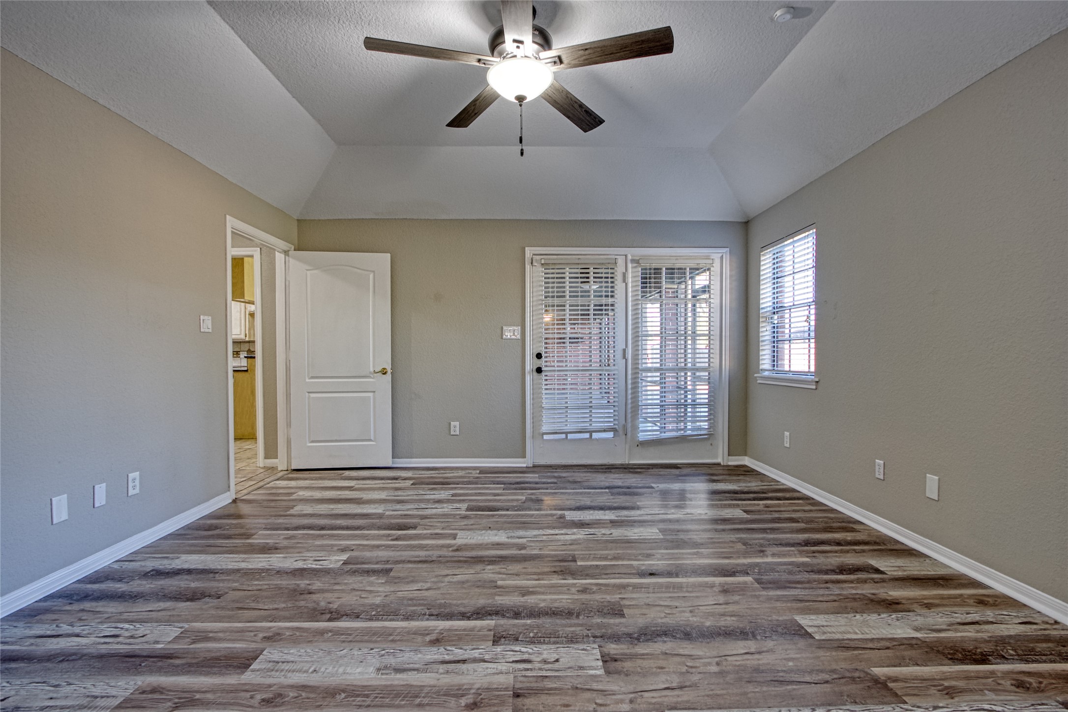 9 North Cay Angleton, TX 77515 - Photo 22 of 30 a view of an empty room with window and chandelier fan