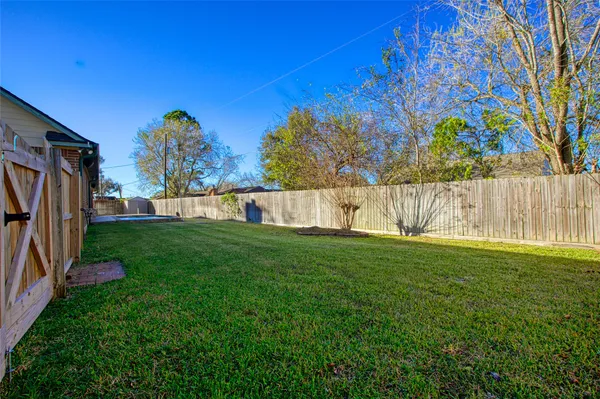 a view of a house with a yard and potted plants