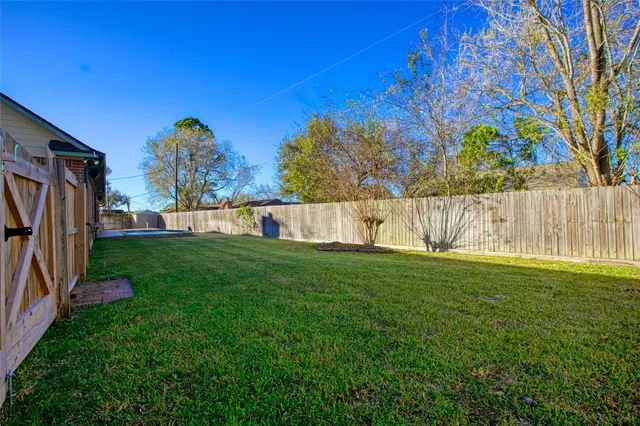 a view of a house with a yard and potted plants