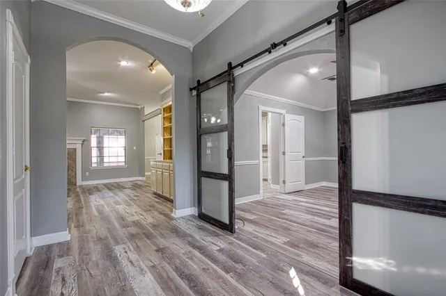 a view of a hallway with wooden floor and staircase