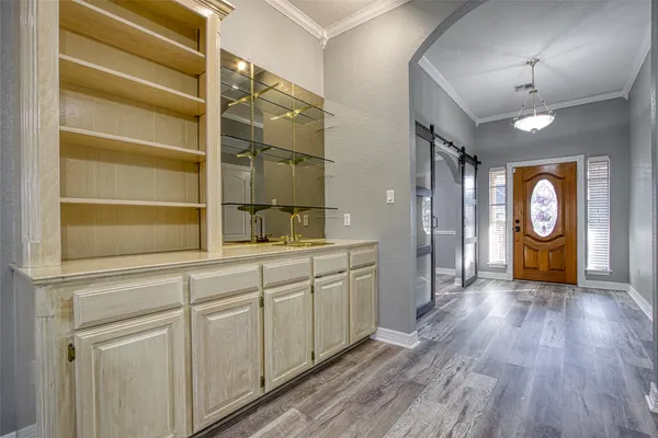 a kitchen with cabinets and wooden floor