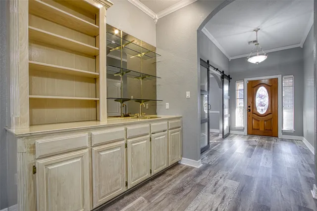 a kitchen with cabinets and wooden floor