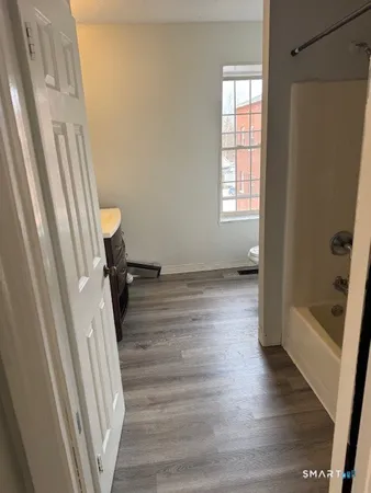 a view of a room with wooden floor and staircase