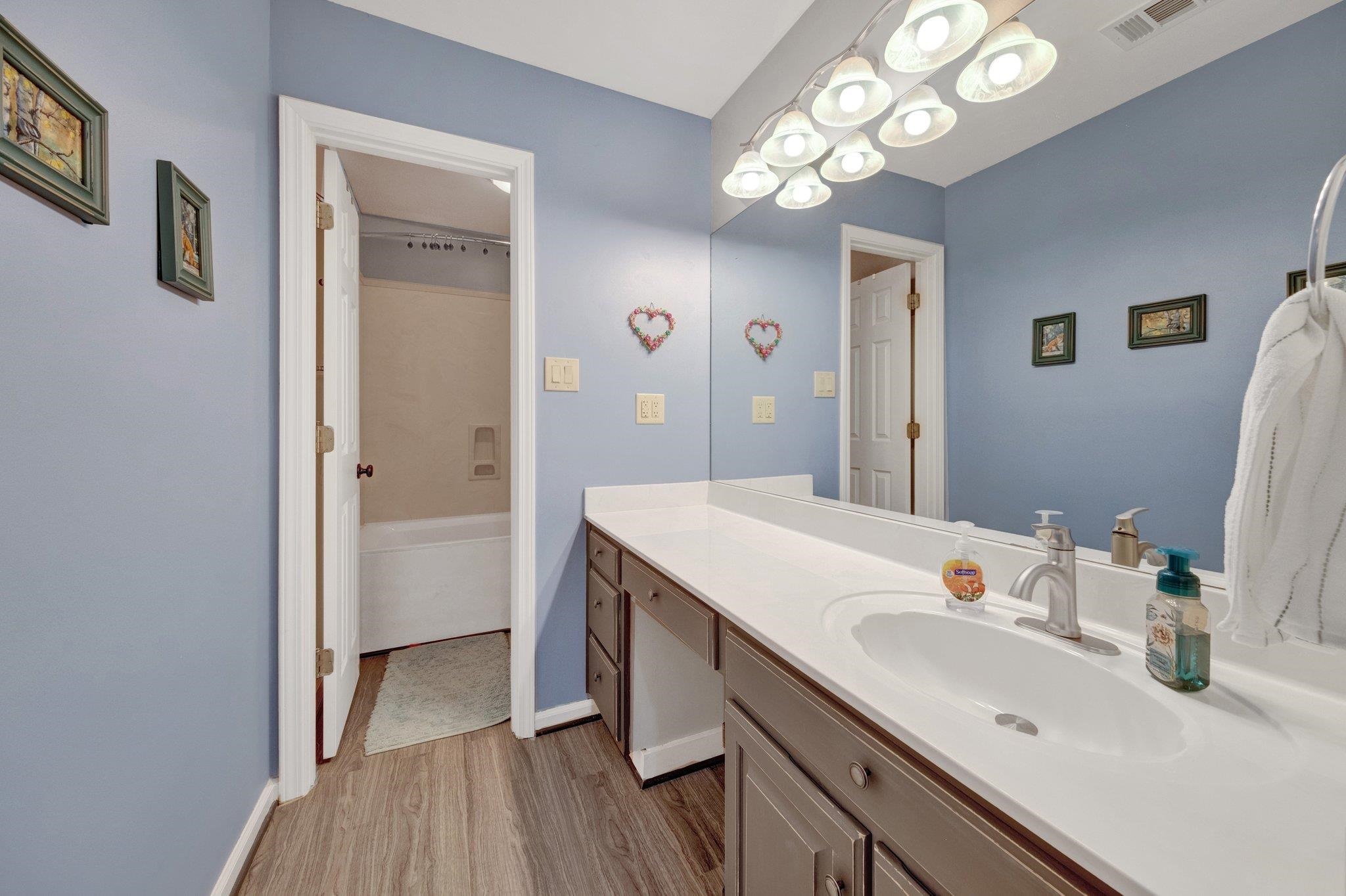 2710 Roland Road Memphis, TN 38002 - Photo 20 of 34 Bathroom featuring wood finished floors, vanity, a bathtub, and a shower