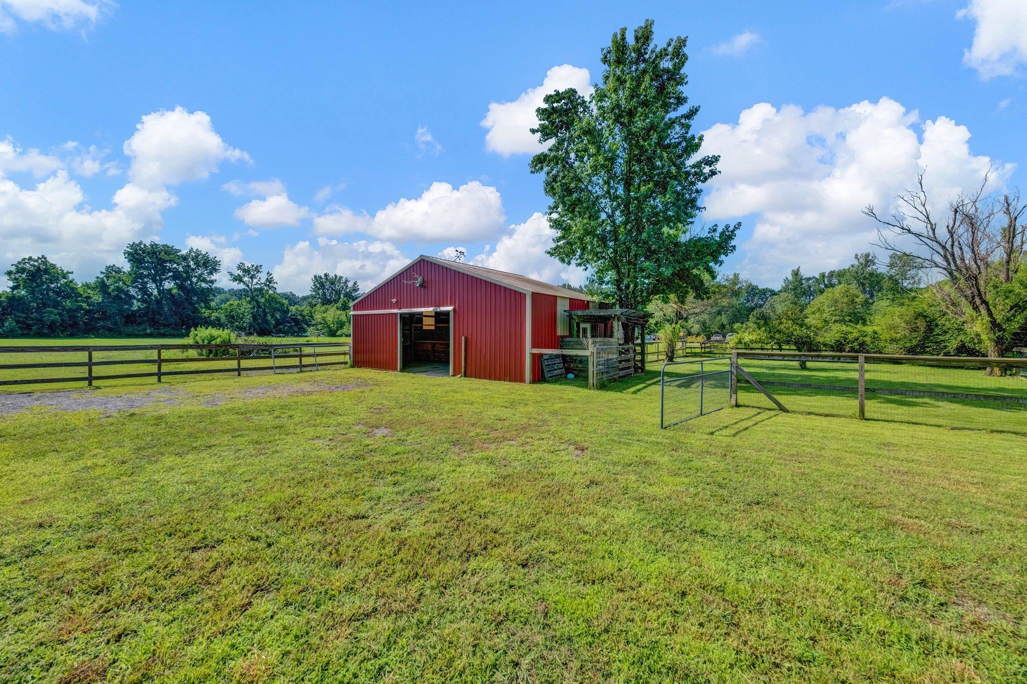 2710 Roland Road Memphis, TN 38002 - Photo 26 of 34 View of yard featuring an outbuilding, a pole building, an exterior structure, a view of countryside, and a detached garage