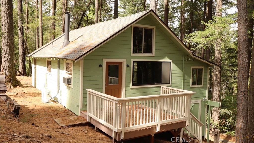 a view of a house with a wooden deck