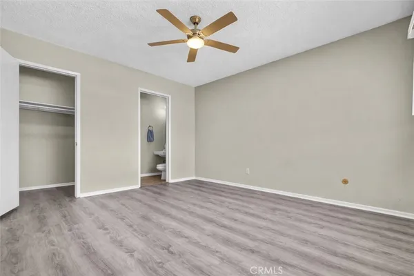 a spacious bathroom with a toilet sink and mirror
