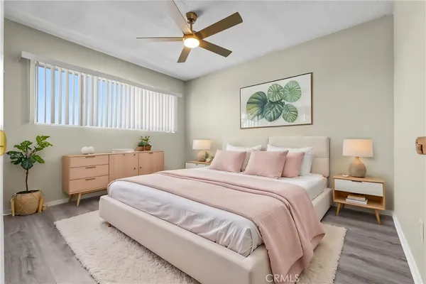 a bedroom with a bed and a painting on the wall